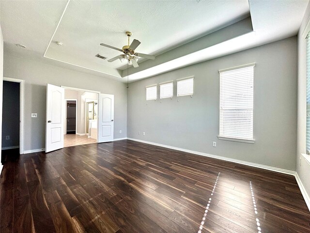 2528 Attwater Way, League City, TX 77573 - unfurnished bedroom featuring a raised ceiling, wood finished floors, and baseboards