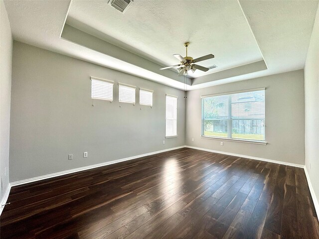 2528 Attwater Way, League City, TX 77573 - unfurnished room with a tray ceiling, dark wood finished floors, a ceiling fan, baseboards, and a textured ceiling