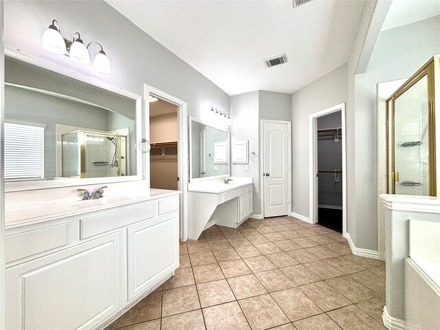 2528 Attwater Way, League City, TX 77573 - full bath featuring a stall shower, a walk in closet, two vanities, tile patterned flooring, and baseboards