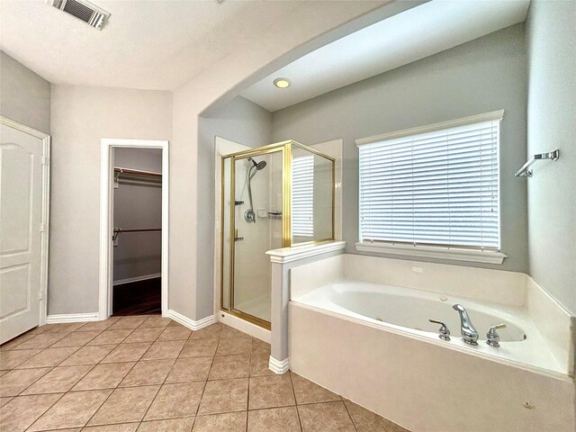 2528 Attwater Way, League City, TX 77573 - full bathroom with a bath, a shower stall, tile patterned flooring, and a spacious closet