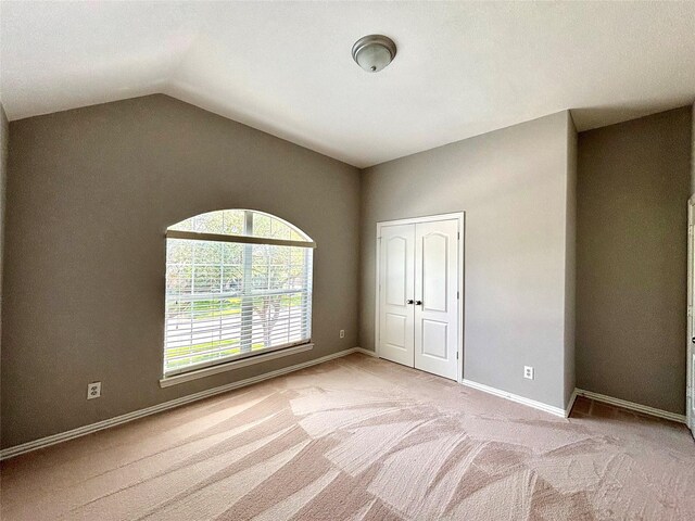 2528 Attwater Way, League City, TX 77573 - unfurnished bedroom with carpet, vaulted ceiling, baseboards, and a closet