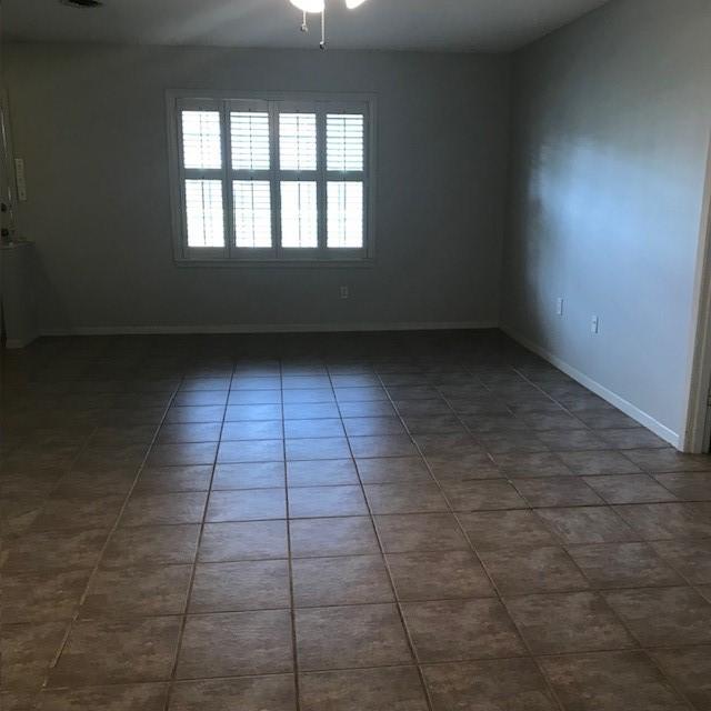 5471 Kuldell Dr, Houston, TX 77096 - spare room featuring baseboards and a ceiling fan