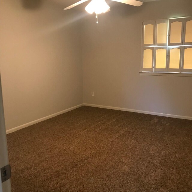 5471 Kuldell Dr, Houston, TX 77096 - spare room featuring dark colored carpet, a ceiling fan, and baseboards