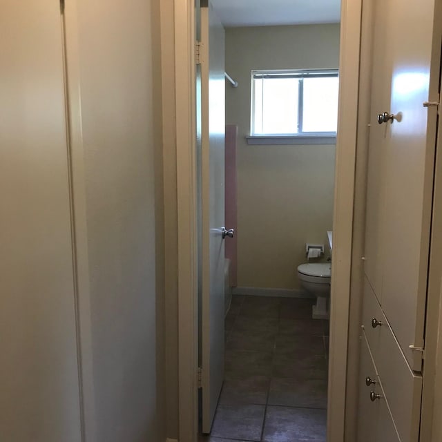 5471 Kuldell Dr, Houston, TX 77096 - bathroom with toilet, tile patterned flooring, and baseboards
