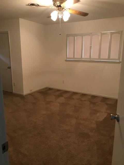 5471 Kuldell Dr, Houston, TX 77096 - spare room with a ceiling fan, dark carpet, and baseboards
