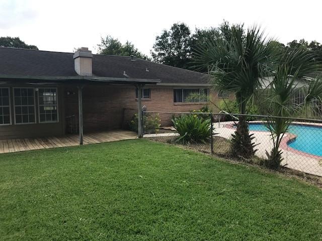 5471 Kuldell Dr, Houston, TX 77096 - back of house with a wooden deck and a chimney