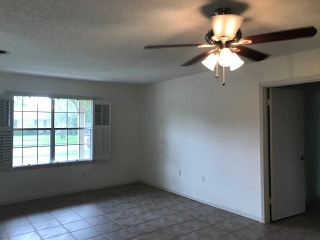 5471 Kuldell Dr, Houston, TX 77096 - tiled spare room with a ceiling fan and a textured ceiling