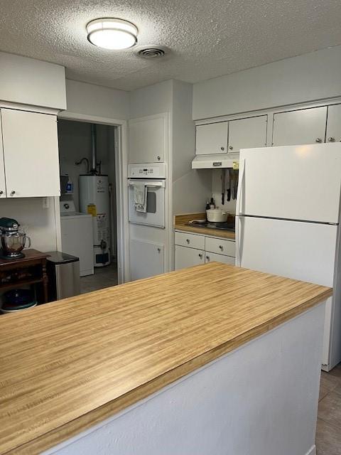 5471 Kuldell Dr, Houston, TX 77096 - kitchen featuring white appliances, under cabinet range hood, gas water heater, washer / clothes dryer, and white cabinets
