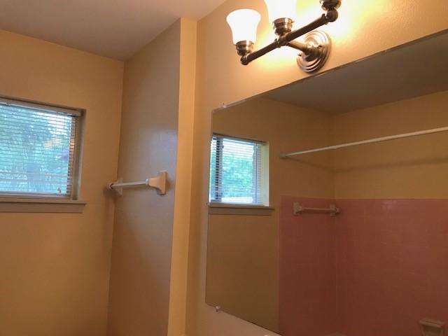 5471 Kuldell Dr, Houston, TX 77096 - bathroom featuring a shower and a chandelier