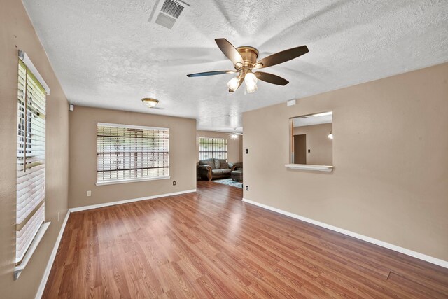 12821 Donegal Way, Houston, TX 77047 - empty room with ceiling fan, a textured ceiling, and wood finished floors