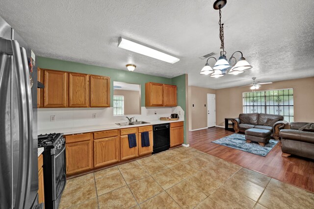 12821 Donegal Way, Houston, TX 77047 - kitchen with stainless steel appliances, open floor plan, a textured ceiling, light countertops, and light tile patterned flooring