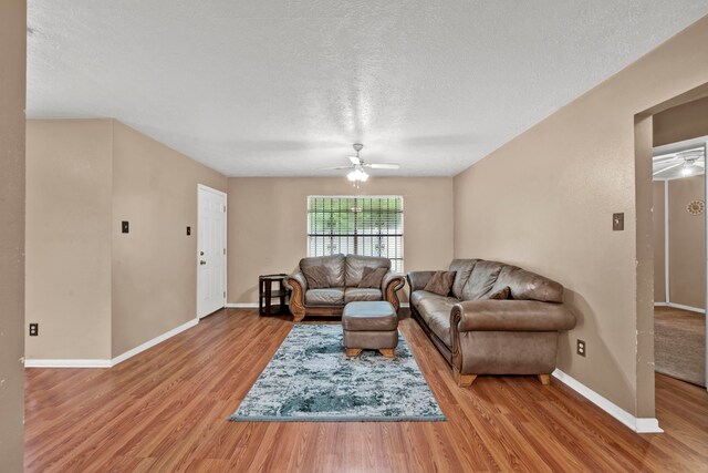 12821 Donegal Way, Houston, TX 77047 - living area with wood finished floors, ceiling fan, and a textured ceiling