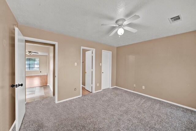 12821 Donegal Way, Houston, TX 77047 - unfurnished bedroom featuring a textured ceiling, carpet, and ceiling fan
