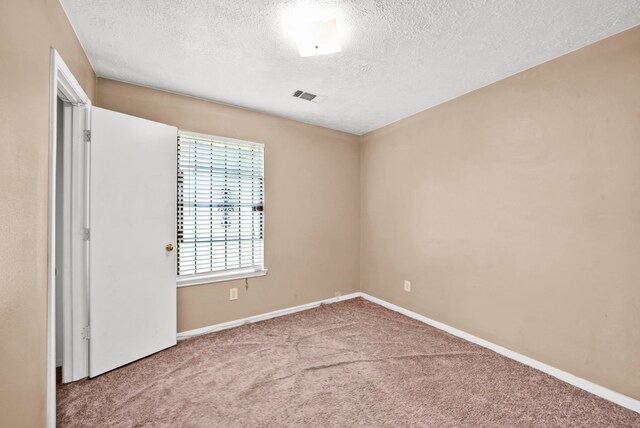 12821 Donegal Way, Houston, TX 77047 - carpeted spare room with a textured ceiling and baseboards