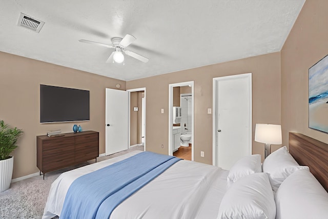 12821 Donegal Way, Houston, TX 77047 - bedroom with ensuite bath, light carpet, and a ceiling fan