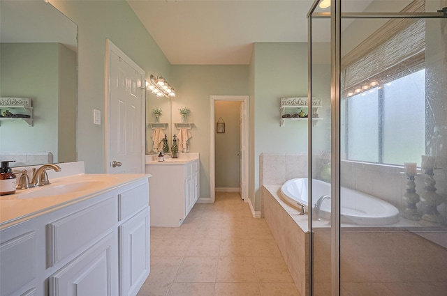 17207 Red Oak Bend Dr, Cypress, TX 77433 - bathroom with two vanities, a bath, a shower stall, and baseboards