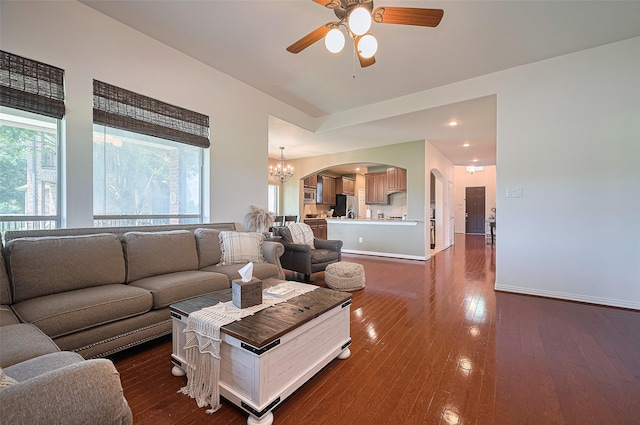 17207 Red Oak Bend Dr, Cypress, TX 77433 - living area featuring ceiling fan, arched walkways, a chandelier, and dark wood-style flooring