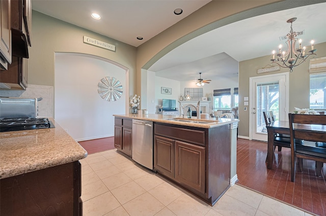 17207 Red Oak Bend Dr, Cypress, TX 77433 - kitchen with dishwasher, a chandelier, a sink, arched walkways, and a ceiling fan
