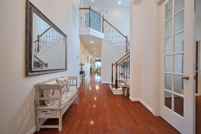 17207 Red Oak Bend Dr, Cypress, TX 77433 - corridor featuring wood finished floors, stairs, baseboards, and a towering ceiling