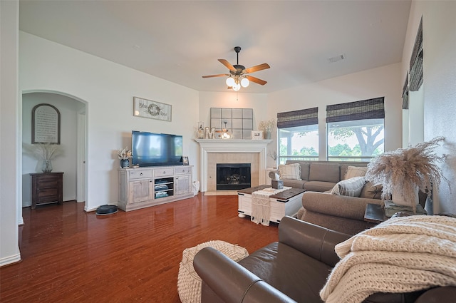 17207 Red Oak Bend Dr, Cypress, TX 77433 - living area featuring a ceiling fan, a fireplace, wood finished floors, arched walkways, and baseboards