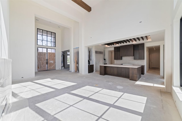 19203 Coleto Creek Bend Dr, Cypress, TX 77433 - unfurnished living room with a towering ceiling and beamed ceiling