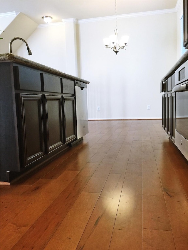 3004 Fairdale Estates Ct, Houston, TX 77057 - kitchen featuring a chandelier, crown molding, dark wood finished floors, hanging light fixtures, and dark cabinets