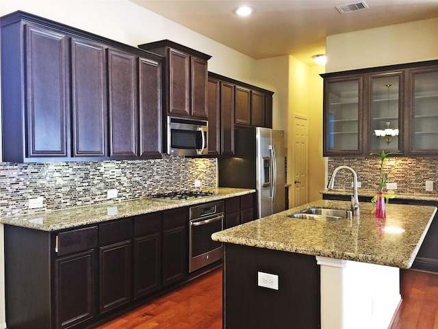3004 Fairdale Estates Ct, Houston, TX 77057 - kitchen featuring stainless steel appliances, a sink, dark wood-style floors, light stone counters, and decorative backsplash