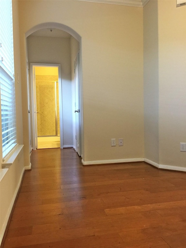 3004 Fairdale Estates Ct, Houston, TX 77057 - spare room featuring arched walkways, wood finished floors, and baseboards
