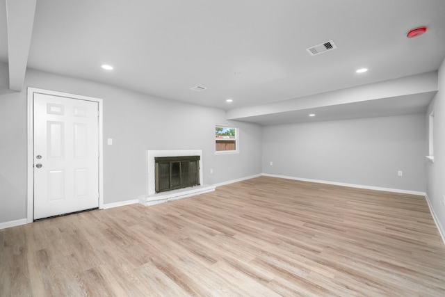 54 Lantana Ct, Lake Jackson, TX 77566 - unfurnished living room featuring recessed lighting, light wood-style flooring, and a glass covered fireplace