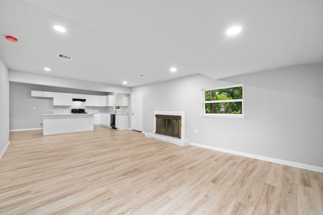 54 Lantana Ct, Lake Jackson, TX 77566 - unfurnished living room featuring recessed lighting, light wood-style floors, and a glass covered fireplace