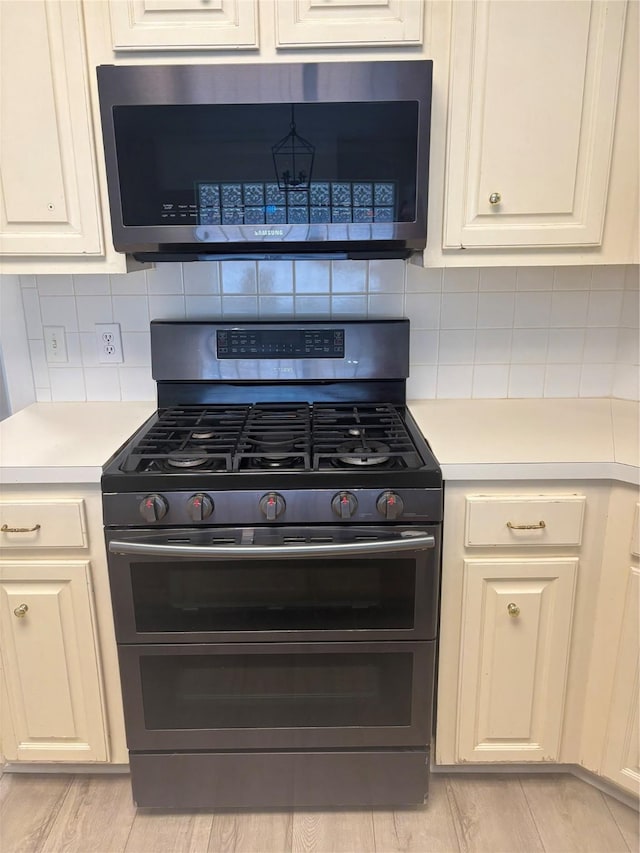 18918 Cypresswood Forest Ct, Spring, TX 77388 - kitchen featuring stainless steel appliances, light countertops, and tasteful backsplash