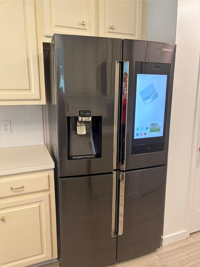18918 Cypresswood Forest Ct, Spring, TX 77388 - kitchen featuring stainless steel fridge, backsplash, light countertops, and light wood-style floors