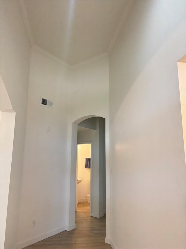 18918 Cypresswood Forest Ct, Spring, TX 77388 - hallway featuring arched walkways, crown molding, light wood-style flooring, baseboards, and a high ceiling