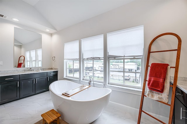 2414 Hollister Rd, Houston, TX 77080 - bathroom with marble look tiles, vanity, vaulted ceiling, and a soaking tub