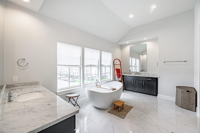 2414 Hollister Rd, Houston, TX 77080 - bathroom featuring two vanities, a soaking tub, lofted ceiling, baseboards, and marble finish floors