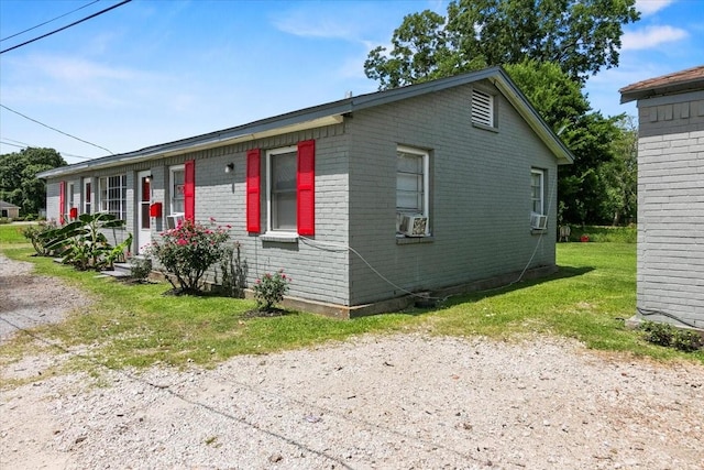 2905 Glenwood St, Beaumont, TX 77705 - view of front of house with brick siding, cooling unit, and a front lawn