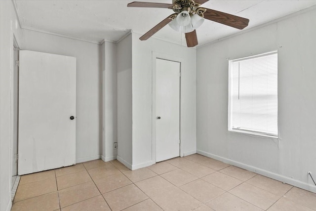 2905 Glenwood St, Beaumont, TX 77705 - unfurnished bedroom featuring light tile patterned floors, crown molding, baseboards, and ceiling fan