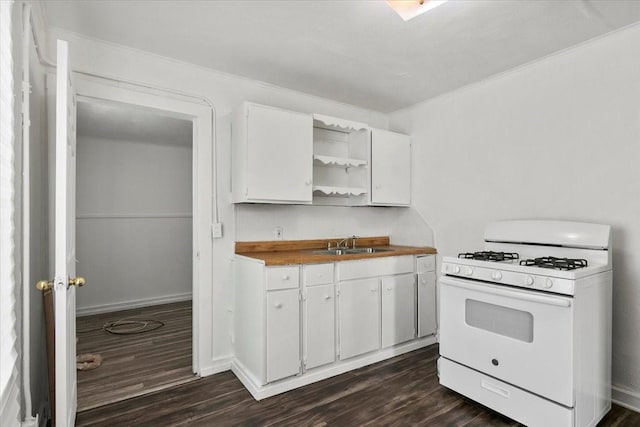 2905 Glenwood St, Beaumont, TX 77705 - kitchen featuring white range with gas cooktop, open shelves, dark wood-style flooring, white cabinets, and crown molding