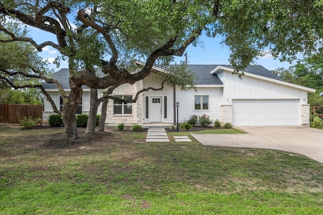 15202 Cavalier Canyon Dr, Lakeway, TX 78734 - view of front of home featuring stone siding, an attached garage, concrete driveway, and roof with shingles