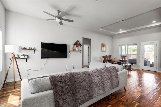 15202 Cavalier Canyon Dr, Lakeway, TX 78734 - living room featuring wood finished floors, a ceiling fan, a tray ceiling, baseboards, and recessed lighting