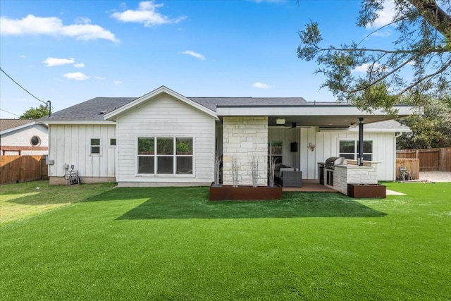 15202 Cavalier Canyon Dr, Lakeway, TX 78734 - back of property with board and batten siding, a patio, stone siding, ceiling fan, and roof with shingles