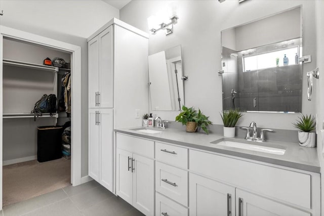 15202 Cavalier Canyon Dr, Lakeway, TX 78734 - full bath with double vanity, a stall shower, tile patterned flooring, and a walk in closet