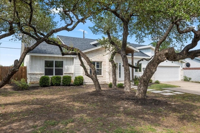 15202 Cavalier Canyon Dr, Lakeway, TX 78734 - view of front of house featuring stone siding, board and batten siding, driveway, and a shingled roof