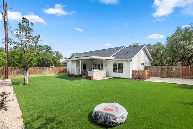 15202 Cavalier Canyon Dr, Lakeway, TX 78734 - back of property featuring board and batten siding, a patio area, ceiling fan, and a shingled roof