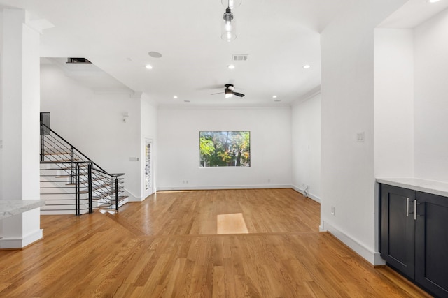 1205 Summer St Unit C, Houston, TX 77007 - unfurnished living room featuring light wood finished floors, ceiling fan, stairs, baseboards, and crown molding