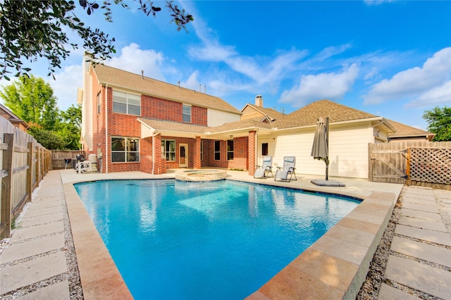 27107 Downing Park Blvd, Katy, TX 77494 - view of swimming pool featuring a fenced backyard, a patio, a pool with connected hot tub, and a gate