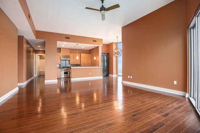 4821 Nasa Pkwy Unit 12E, Pasadena, TX 77586 - unfurnished living room with dark wood-type flooring, ceiling fan, and baseboards