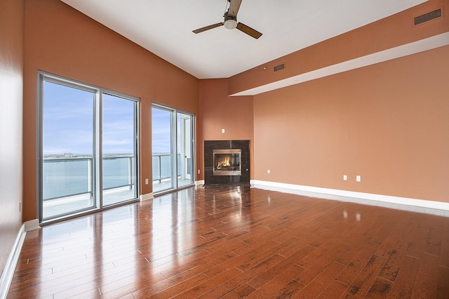 4821 Nasa Pkwy Unit 12E, Pasadena, TX 77586 - unfurnished living room with wood finished floors, ceiling fan, a fireplace, and baseboards