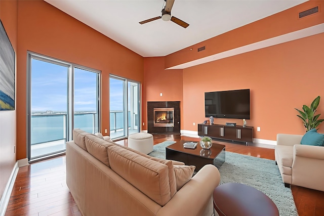 4821 Nasa Pkwy Unit 12E, Pasadena, TX 77586 - living area with ceiling fan, wood finished floors, a premium fireplace, and baseboards