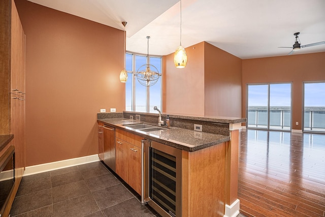 4821 Nasa Pkwy Unit 12E, Pasadena, TX 77586 - kitchen featuring beverage cooler, a sink, a peninsula, stainless steel dishwasher, and open floor plan